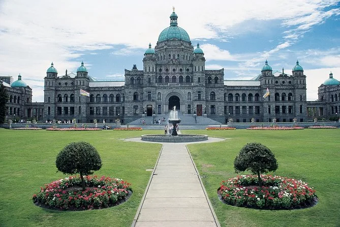The domed Parliament Buildings behind a formal lawn with a fountain